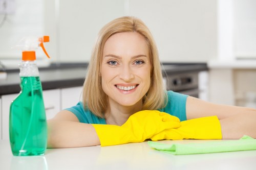 Technician assessing fabric furniture for cleaning in NW3